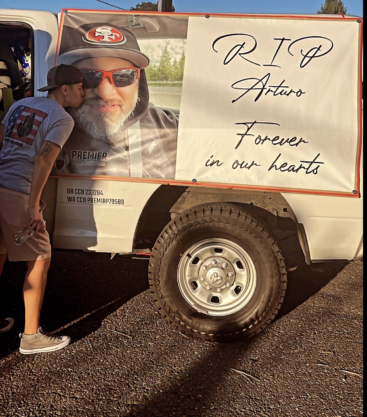 RIP Arturo memorial banner on Premier Restoration truck