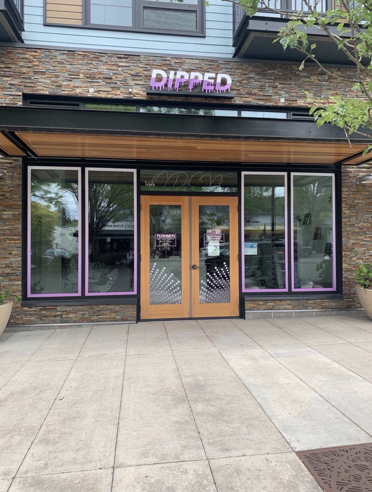 DIPPED storefront with window graphics and signage