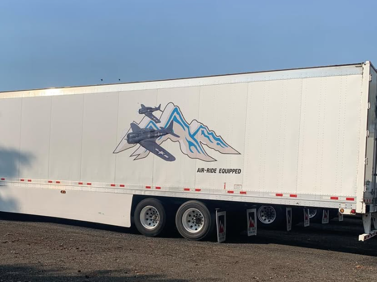 Custom mountain and jet graphic printed on a 53-foot trailer