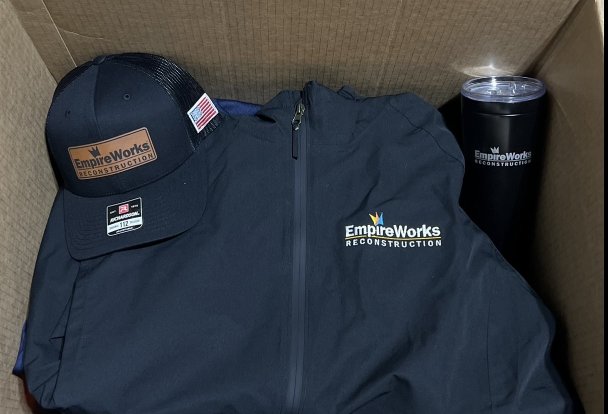EmpireWorks jacket, hat, and tumbler branded swag kit