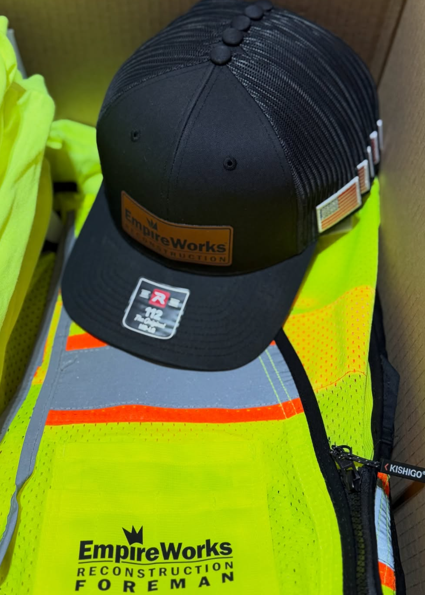 Leather patch trucker hat and hi-vis foreman vest branded for EmpireWorks Reconstruction